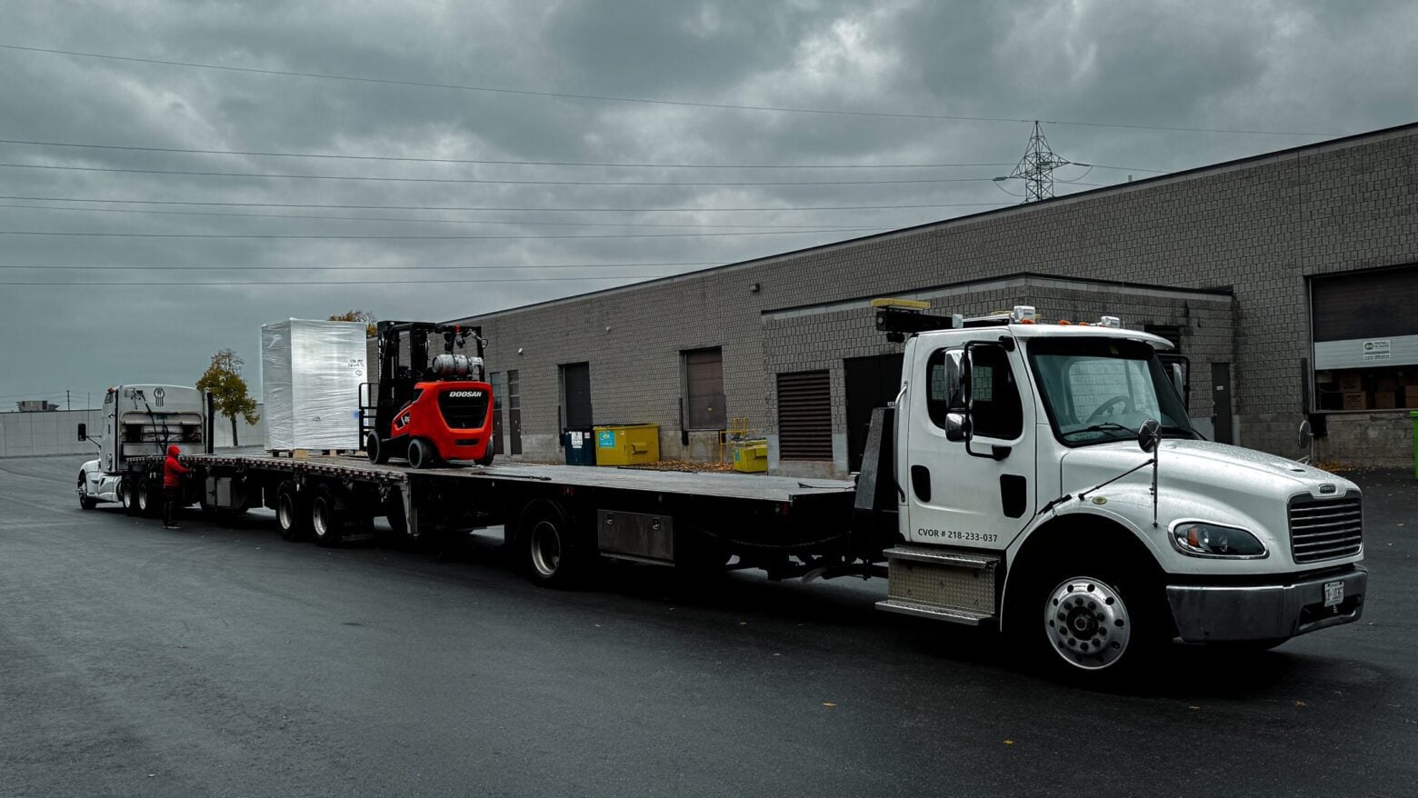 Moving machine from one truck to another