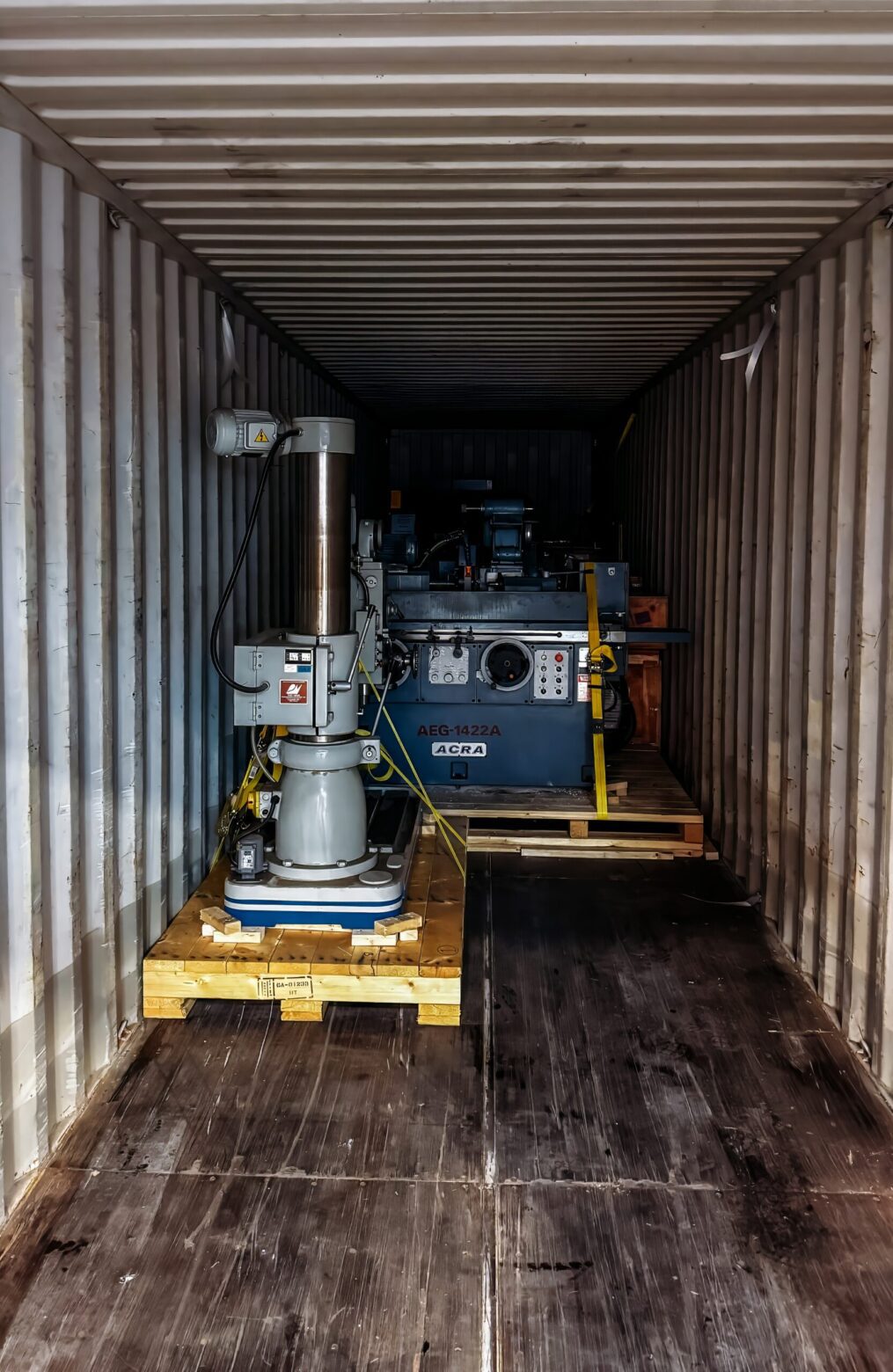 Industrial machine secured and blocked inside shipping container for transport